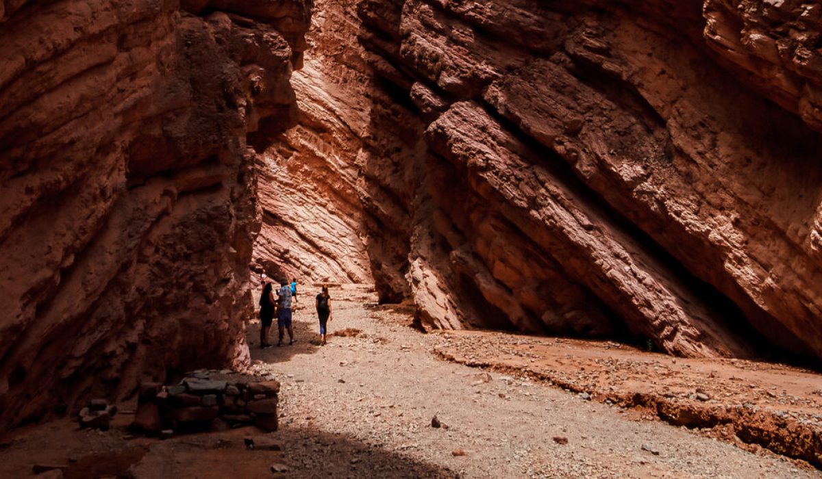 Cafayate, Salta, Argentina - January 11, 2021: Tourists tour the Amphitheater formation in the Quebrada de las Conchas Nature Reserve during a hot afternoon