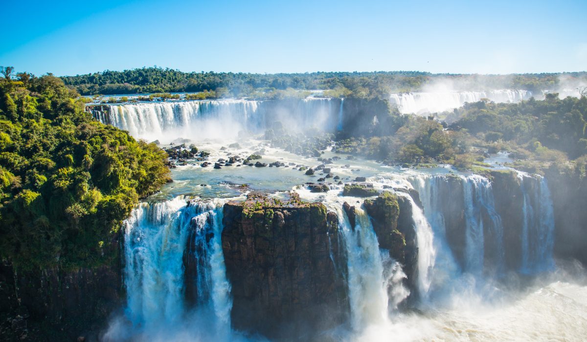 Iguazu Falls is located where the Iguazu River tumbles over the edge of the Paraná Plateau, 23 kilometres (14 mi) upriver from the Iguazu's confluence with the Paraná River.